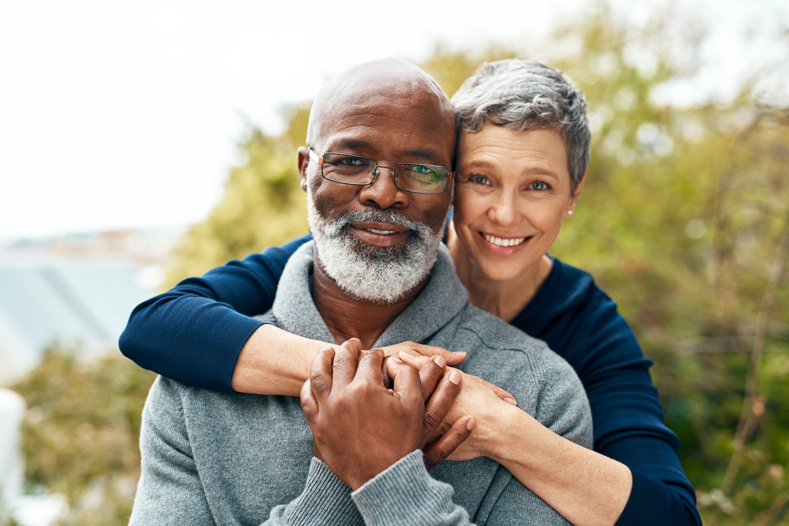 An older couple smiling together outdoors