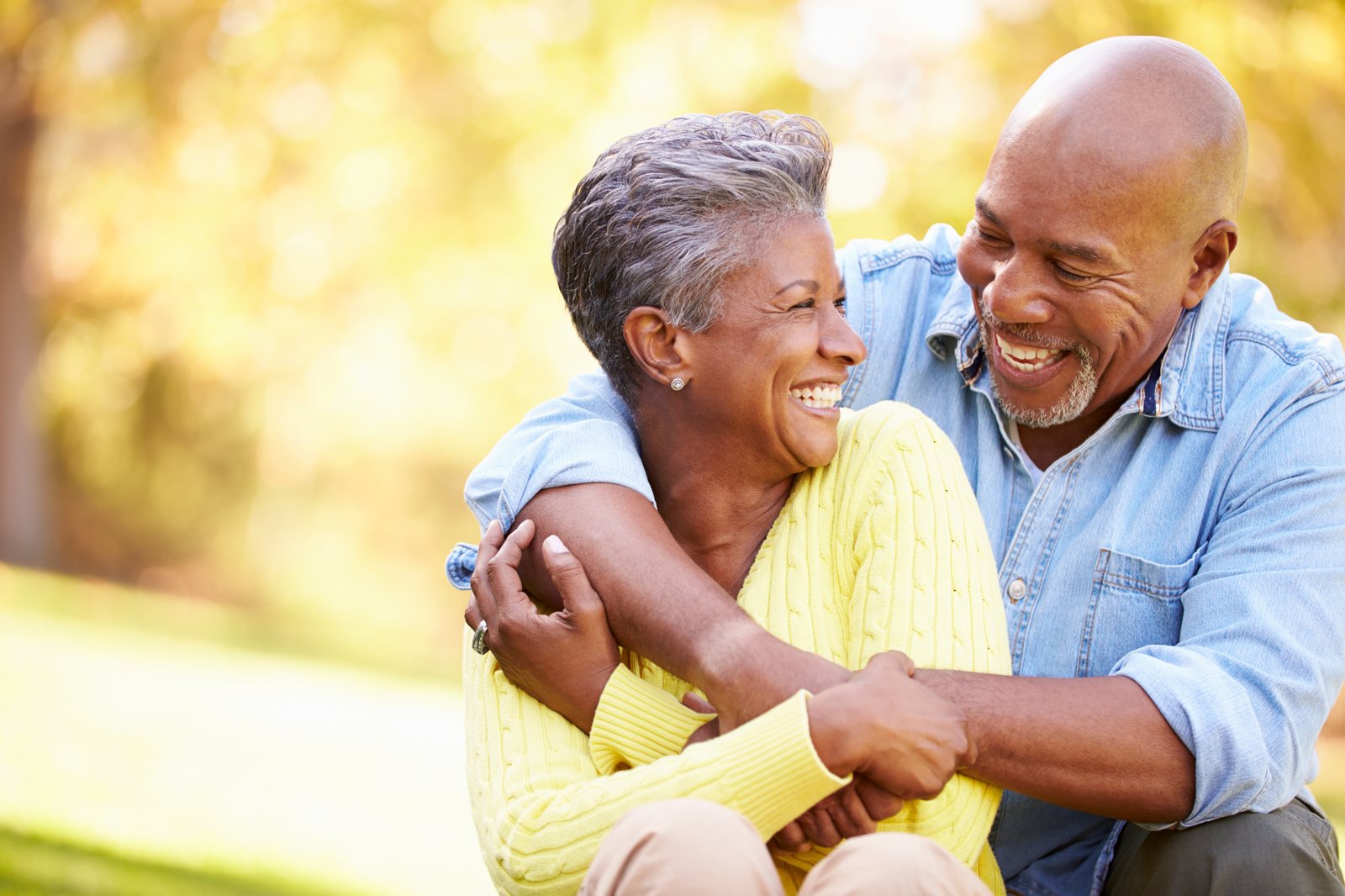 A happy older couple embracing outdoors